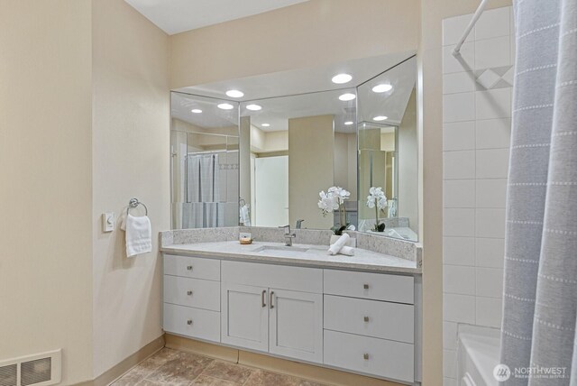 full bathroom with visible vents, baseboards, recessed lighting, vanity, and a shower