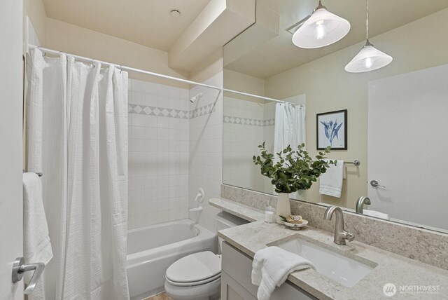 full bathroom with vanity, shower / tub combo, and toilet