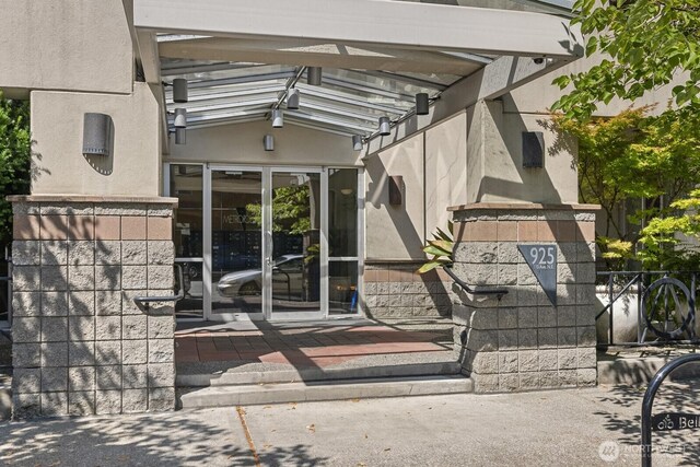 property entrance with stucco siding