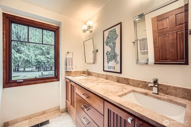 full bathroom featuring tile patterned flooring, double vanity, visible vents, and a sink