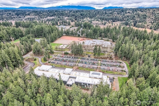 aerial view with a mountain view and a wooded view