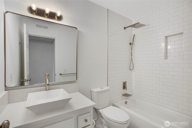 full bathroom featuring vanity, visible vents, bathtub / shower combination, toilet, and a textured wall