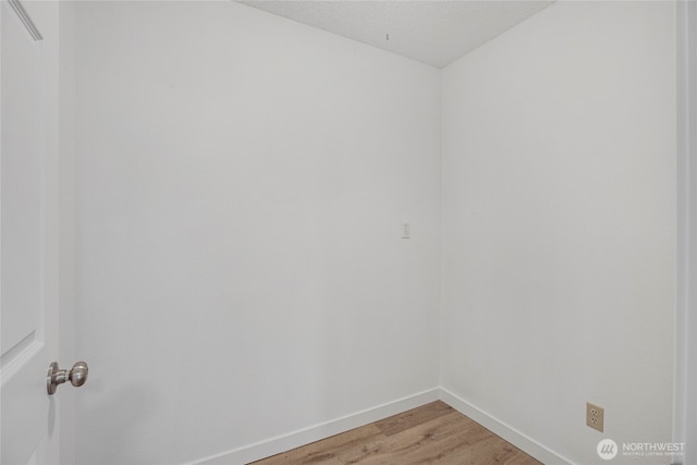 empty room with baseboards and light wood-style floors