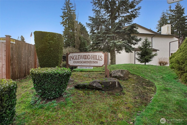 community sign featuring a yard and fence