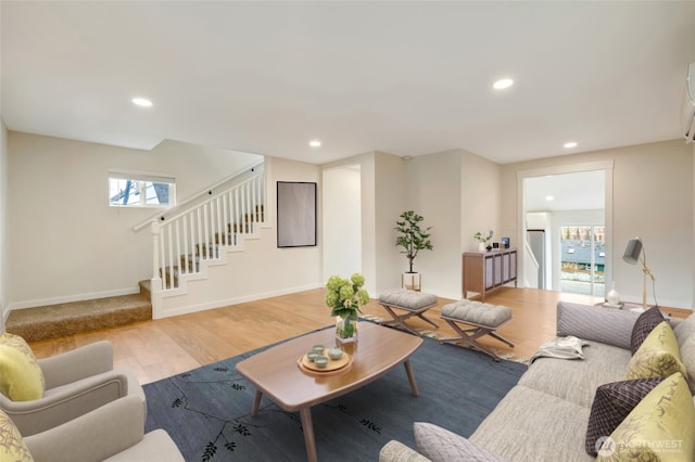 living area featuring recessed lighting, stairway, baseboards, and wood finished floors