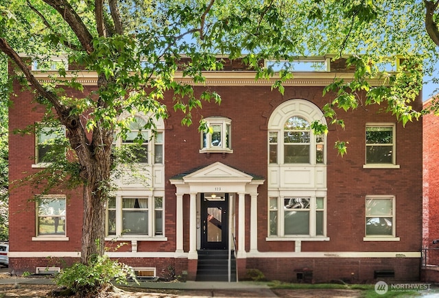 view of front facade featuring brick siding and entry steps