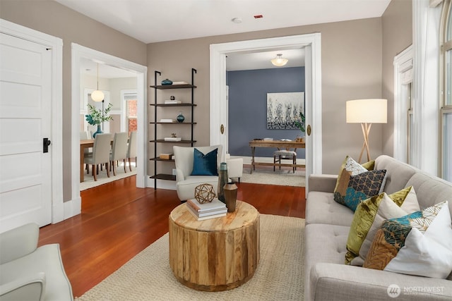 living area featuring baseboards and wood finished floors