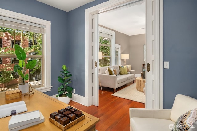 interior space featuring baseboards and wood finished floors