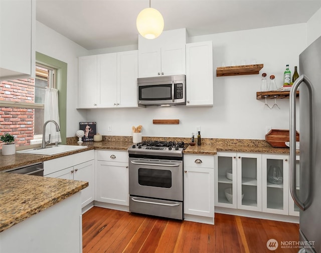 kitchen with white cabinetry, wood-type flooring, appliances with stainless steel finishes, and a sink