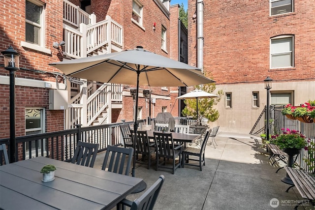 view of patio featuring outdoor dining space and stairway