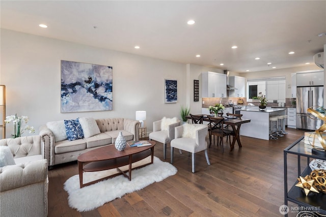 living area featuring dark wood-type flooring and recessed lighting