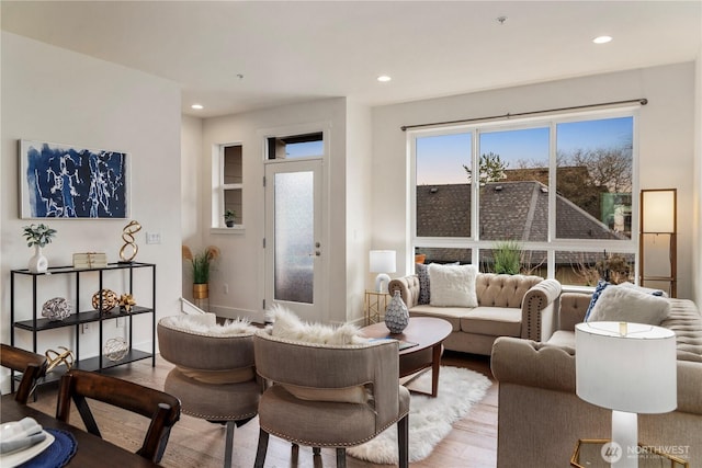 living area with recessed lighting, baseboards, and wood finished floors