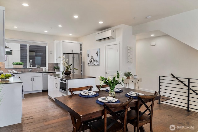 dining space featuring recessed lighting, dark wood-style floors, and a wall unit AC