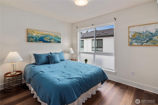 bedroom with wood finished floors and baseboards