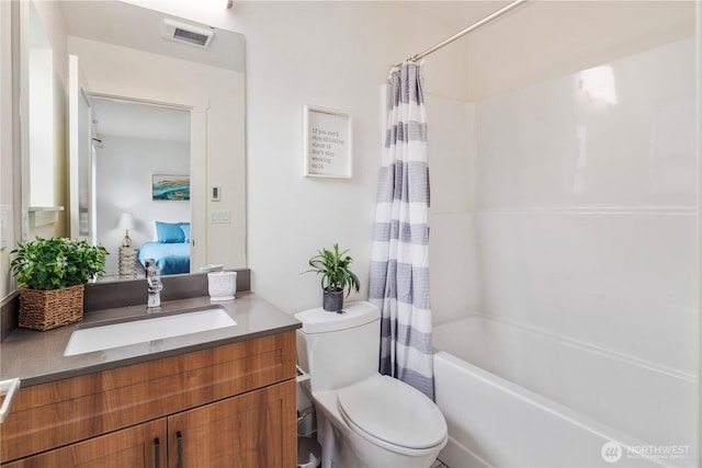 ensuite bathroom with visible vents, toilet, connected bathroom, shower / tub combo, and vanity