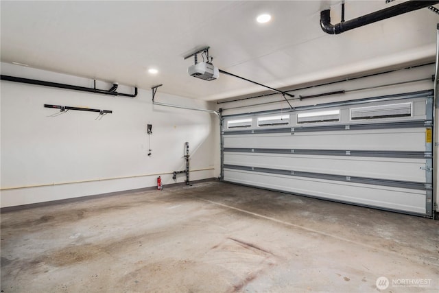 garage with recessed lighting and a garage door opener