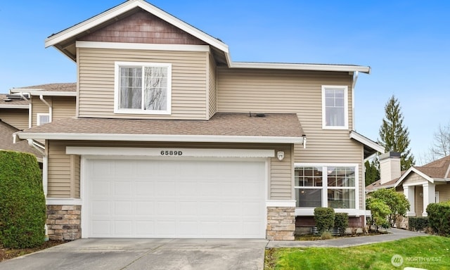 view of front of home with concrete driveway, an attached garage, stone siding, and a shingled roof