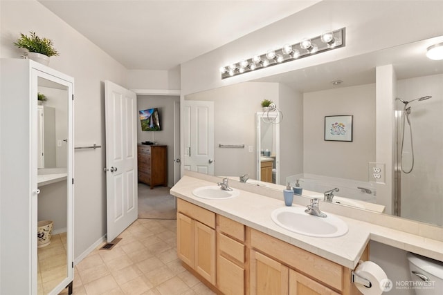 full bathroom with a garden tub, walk in shower, double vanity, and a sink