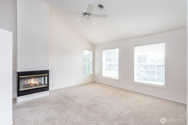 unfurnished living room featuring a ceiling fan, visible vents, high vaulted ceiling, a multi sided fireplace, and carpet flooring