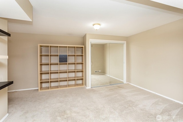 interior space featuring visible vents, baseboards, and carpet flooring