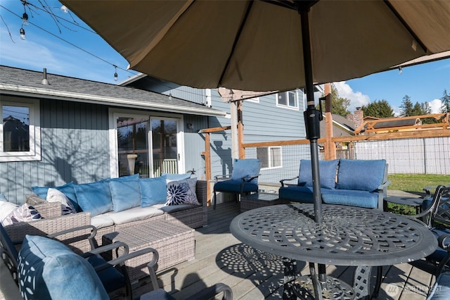 deck featuring an outdoor hangout area and fence