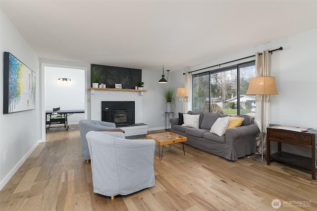 living room featuring light wood-type flooring and baseboards