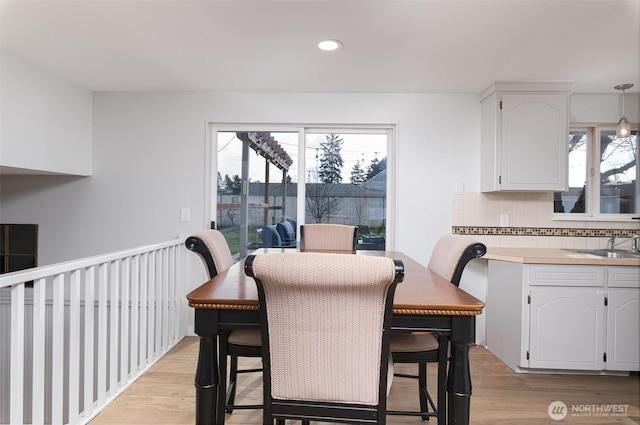 dining area with plenty of natural light, light wood-style floors, and recessed lighting