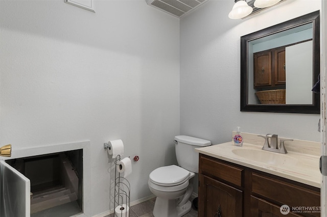 half bath featuring vanity, toilet, and visible vents