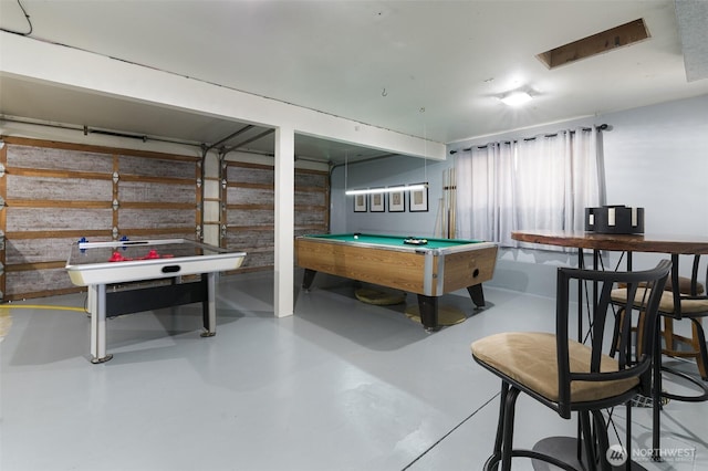 recreation room with billiards, a garage, and concrete flooring