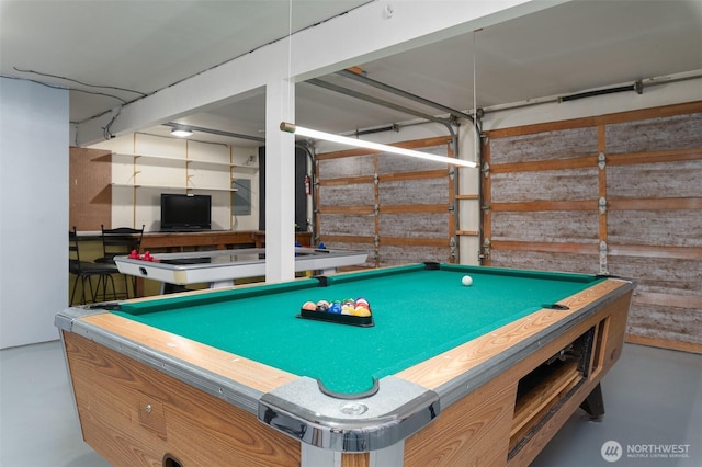 game room with concrete floors and a garage