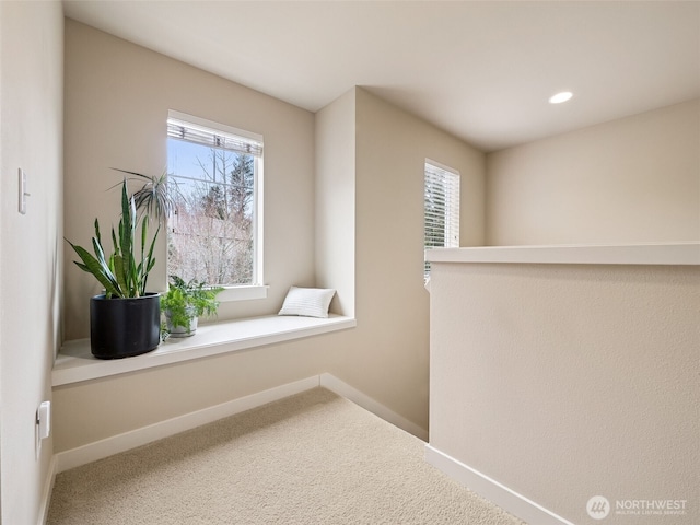 corridor with carpet flooring, recessed lighting, and baseboards