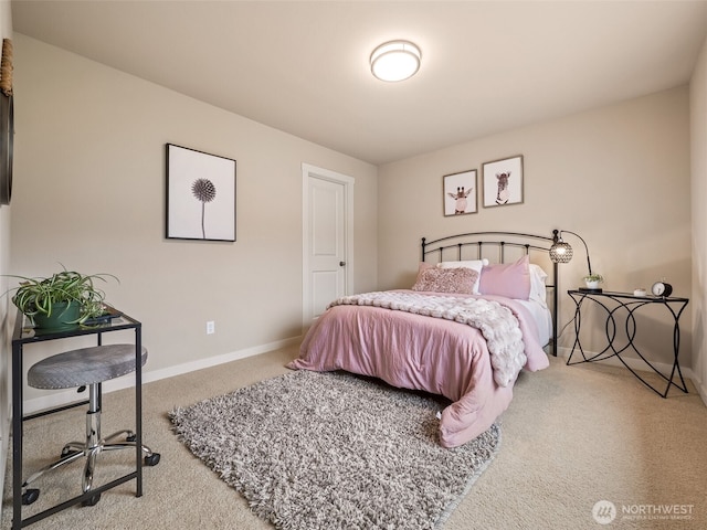 bedroom with baseboards and carpet