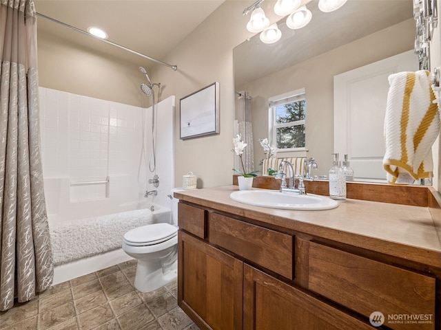 bathroom featuring vanity, toilet, and shower / bath combo with shower curtain