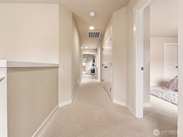 corridor featuring visible vents, recessed lighting, baseboards, and carpet