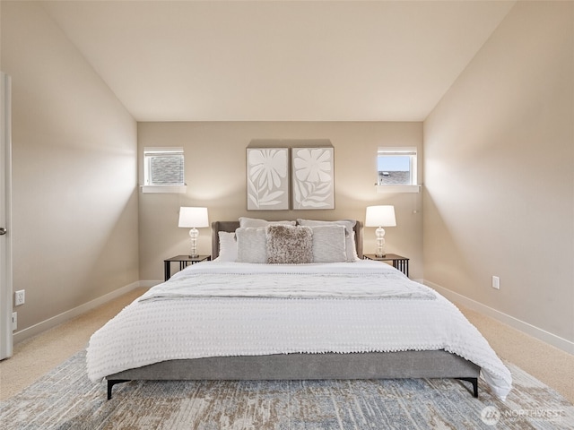 carpeted bedroom featuring baseboards, multiple windows, and lofted ceiling