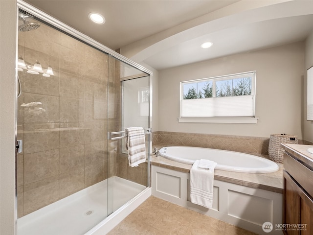 full bath featuring a bath, tile patterned flooring, a shower stall, and vanity