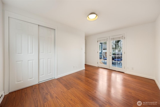 unfurnished bedroom featuring access to exterior, french doors, baseboards, and wood finished floors