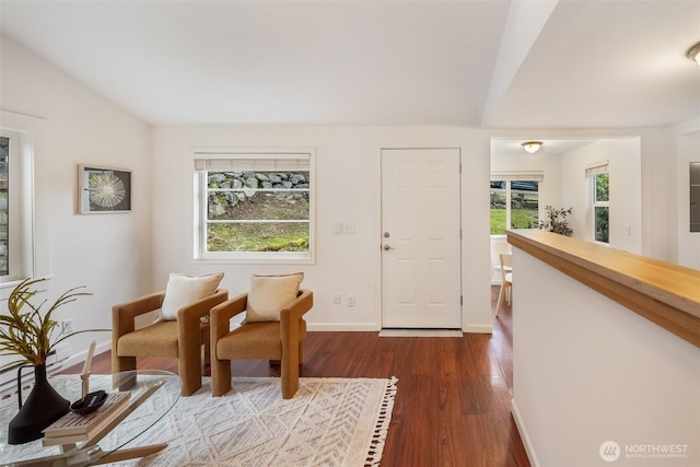 sitting room featuring baseboards, plenty of natural light, lofted ceiling, and dark wood-style floors