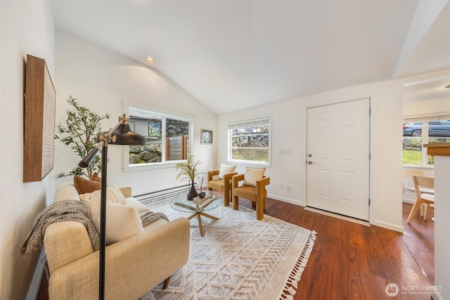 living area featuring vaulted ceiling, wood finished floors, baseboards, and baseboard heating