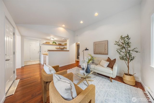 living area with recessed lighting, baseboards, wood finished floors, and vaulted ceiling