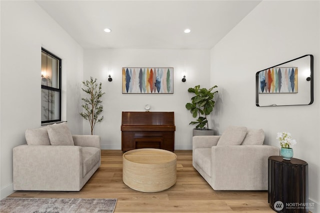 living area with recessed lighting, baseboards, and wood finished floors