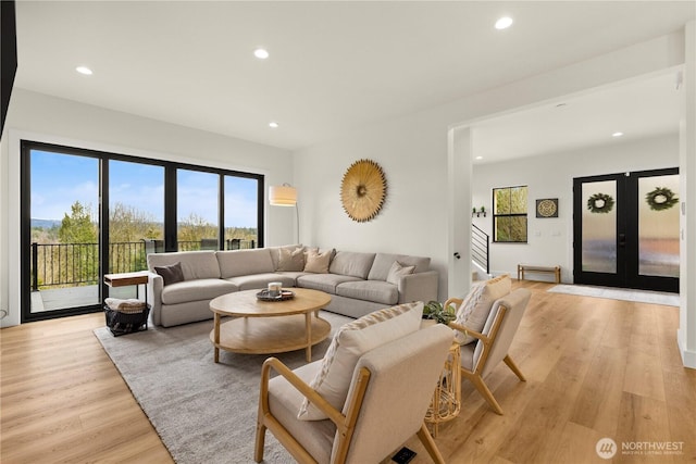 living room featuring recessed lighting, french doors, and light wood-style floors