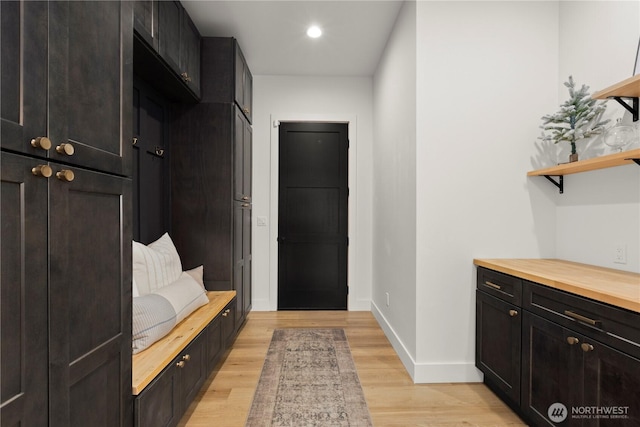 mudroom featuring recessed lighting, light wood-style floors, and baseboards