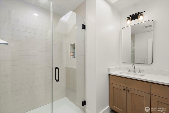 bathroom with vanity and a stall shower