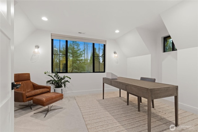 office featuring visible vents, lofted ceiling, and baseboards