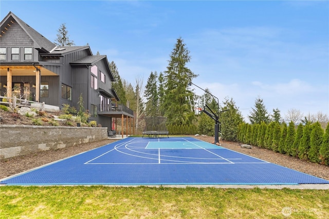 view of sport court with basketball court and a trampoline