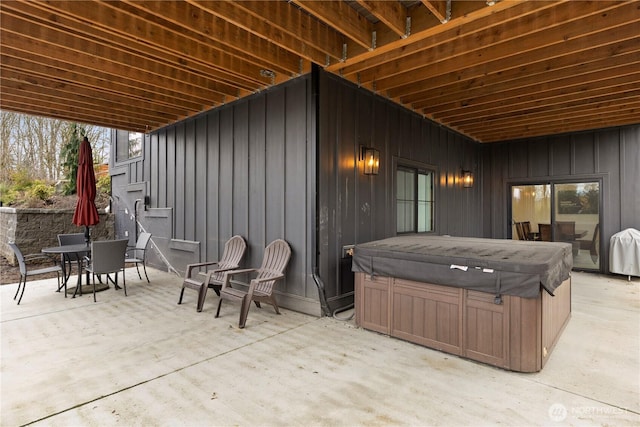 view of patio featuring outdoor dining space and a hot tub