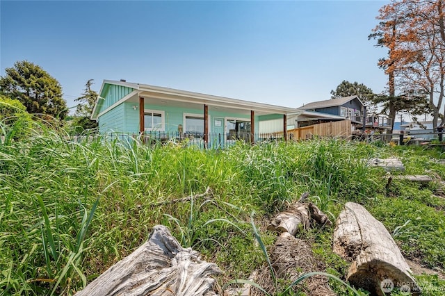 rear view of property with fence