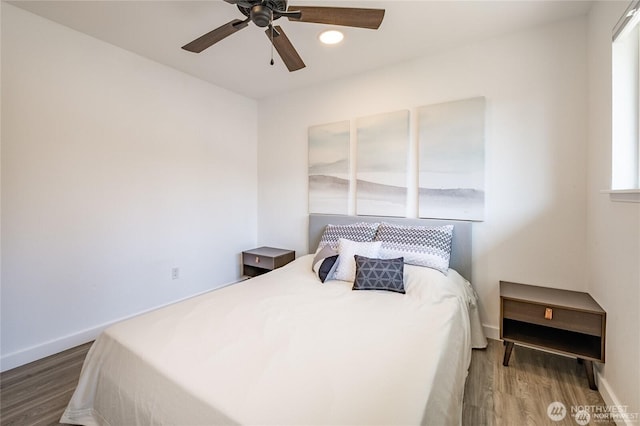 bedroom with wood finished floors, baseboards, and ceiling fan