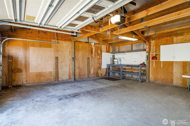 garage with a workshop area and a garage door opener